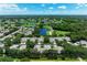 Beautiful aerial view of the neighborhood featuring lush landscaping, serene lakes, and manicured golf courses at 6325 Stone River Rd, Bradenton, FL 34203