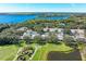 Scenic aerial view of condo community with golf course, lake, and lush landscaping, offering a serene and luxurious lifestyle at 6325 Stone River Rd, Bradenton, FL 34203