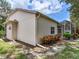 Home backyard featuring neutral colored exterior, well-placed shrubbery and screened in porch at 6325 Stone River Rd, Bradenton, FL 34203