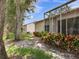 Backyard with mature trees, minimal grass, and a screened lanai off of the back of the home at 6325 Stone River Rd, Bradenton, FL 34203