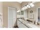 Well-lit bathroom with granite countertop, dual sinks, and white cabinetry at 6325 Stone River Rd, Bradenton, FL 34203
