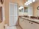 Neutral bathroom boasts granite counters, dual sinks, and ample storage space at 6325 Stone River Rd, Bradenton, FL 34203