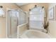 Bathroom with a large soaking tub and walk-in shower at 6325 Stone River Rd, Bradenton, FL 34203