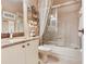 Bathroom featuring marble countertops, a tub with shower, and tile flooring at 6325 Stone River Rd, Bradenton, FL 34203