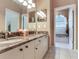 Bright bathroom featuring dual sinks, marble countertop, and large mirror at 6325 Stone River Rd, Bradenton, FL 34203