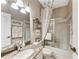 Bathroom features a shower-tub combo, granite countertops and decorative shower curtain at 6325 Stone River Rd, Bradenton, FL 34203