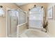 Bathroom features a glass shower, soaking tub and a large bright window at 6325 Stone River Rd, Bradenton, FL 34203