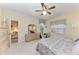 Bright bedroom features neutral carpet, ceiling fan, and access to lanai at 6325 Stone River Rd, Bradenton, FL 34203
