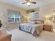 Comfortable bedroom features neutral tones, ceiling fan, and large window offering natural light at 6325 Stone River Rd, Bradenton, FL 34203