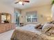 Bedroom featuring a sliding glass door to a patio, a ceiling fan, and soft decor at 6325 Stone River Rd, Bradenton, FL 34203