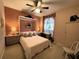 Inviting bedroom with a custom Murphy bed, built in shelves and a ceiling fan at 6325 Stone River Rd, Bradenton, FL 34203
