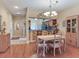 Dining room and view of kitchen and living room with hardwood floors and chandelier at 6325 Stone River Rd, Bradenton, FL 34203