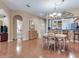 Open-concept dining room with hardwood floors and a view into the kitchen and bedrooms at 6325 Stone River Rd, Bradenton, FL 34203