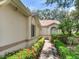 Beautiful home exterior with well-manicured landscaping, a walkway, and lovely architectural details at 6325 Stone River Rd, Bradenton, FL 34203