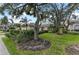 Exterior of house with mature landscaping and large trees at 6325 Stone River Rd, Bradenton, FL 34203