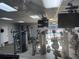 Well-equipped fitness center with various exercise machines and a view of pool at 6325 Stone River Rd, Bradenton, FL 34203