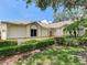Charming home exterior with lush landscaping, manicured hedges, and a well-maintained lawn at 6325 Stone River Rd, Bradenton, FL 34203