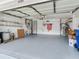Spacious garage with ample storage, including ladder, storage shelf, and an American flag at 6325 Stone River Rd, Bradenton, FL 34203