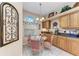 Bright kitchen nook featuring a glass table, tile floors, natural light, and functional cabinetry at 6325 Stone River Rd, Bradenton, FL 34203