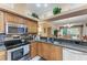 Open-concept kitchen with stainless steel appliances, granite countertops, and seamless flow into the living area for easy entertaining at 6325 Stone River Rd, Bradenton, FL 34203