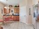 Bright eat-in kitchen with stainless refrigerator and oak cabinets at 6325 Stone River Rd, Bradenton, FL 34203