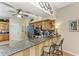 Stylish kitchen featuring granite countertops, stainless steel appliances, a breakfast bar, and ample cabinet space at 6325 Stone River Rd, Bradenton, FL 34203