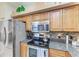 Modern kitchen featuring stainless steel appliances, granite countertops, and stylish backsplash, perfect for cooking and entertaining at 6325 Stone River Rd, Bradenton, FL 34203