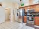 Well-lit kitchen featuring stainless steel appliances and tiled flooring at 6325 Stone River Rd, Bradenton, FL 34203