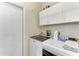 Laundry room features front loading washer and dryer with storage cabinets at 6325 Stone River Rd, Bradenton, FL 34203