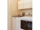 Laundry room featuring Maytag washer and dryer, with upper cabinets for storage at 6325 Stone River Rd, Bradenton, FL 34203