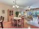 Open living space with hardwood flooring, and view to dining area and screened patio at 6325 Stone River Rd, Bradenton, FL 34203