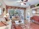 Comfortable living room with hardwood floors, ceiling fan, and access to the patio at 6325 Stone River Rd, Bradenton, FL 34203