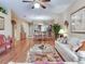 Bright, open living space featuring hardwood floors, neutral decor, and a seamless flow to the kitchen and dining area at 6325 Stone River Rd, Bradenton, FL 34203
