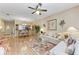 Inviting living room with hardwood floors, comfortable seating, and an open layout to the dining area at 6325 Stone River Rd, Bradenton, FL 34203