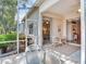 Covered and screened patio with tile flooring and access to the interior at 6325 Stone River Rd, Bradenton, FL 34203