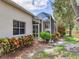 Backyard featuring screen porch and lush green yard at 6325 Stone River Rd, Bradenton, FL 34203