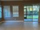 Living area with tile floors, windows with blinds, and sliding glass door to the backyard at 7009 Makers Way, Apollo Beach, FL 33572