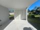Covered back patio with white walls and door at 735 Bertrend St, Englewood, FL 34223