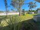 Large backyard with trees and privacy fence at 735 Bertrend St, Englewood, FL 34223