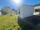 White shed in backyard with single door at 735 Bertrend St, Englewood, FL 34223