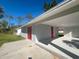 Home with covered entry and red doors at 735 Bertrend St, Englewood, FL 34223