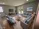 Virtually staged living room with grey sofas and coffee table at 735 Bertrend St, Englewood, FL 34223