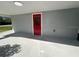Covered side porch with red door access at 735 Bertrend St, Englewood, FL 34223