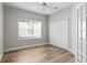 Bright bedroom featuring wood-look floors, and a double door closet at 7512 Surrey Pines Dr, Apollo Beach, FL 33572