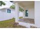 Inviting outdoor back porch entrance boasting tiled floors, offering a welcoming transition to indoor living at 8317 N Ogontz Ave, Tampa, FL 33604