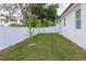 The home features a well-maintained backyard, enclosed by a white fence, offering a private outdoor space at 8317 N Ogontz Ave, Tampa, FL 33604