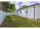 The home features a well-maintained backyard, enclosed by a white fence, offering a private outdoor space at 8317 N Ogontz Ave, Tampa, FL 33604