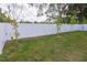 The home features a well-maintained backyard, enclosed by a white fence, offering a private outdoor space at 8317 N Ogontz Ave, Tampa, FL 33604