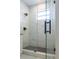 Glass shower featuring matte black fixtures and tile floors at 8317 N Ogontz Ave, Tampa, FL 33604