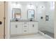Modern bathroom with dual sinks, granite countertops, and stylish glass-enclosed shower at 8317 N Ogontz Ave, Tampa, FL 33604